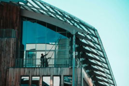 a-man-standing-on-a-balcony-of-a-building.jpg A man standing on a balcony of a building